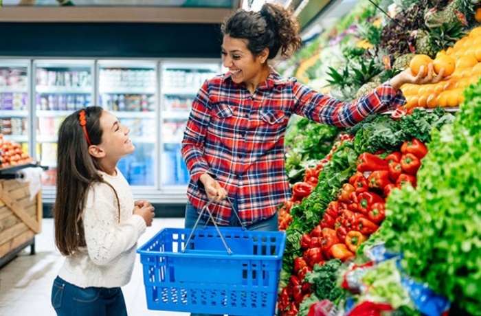 young girl and woman shopping for produce