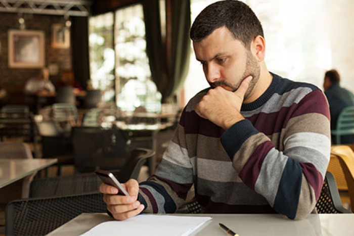 man looking at his phone