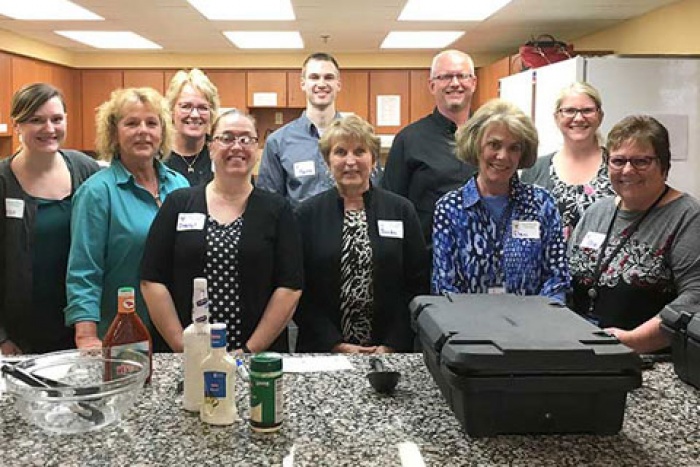 ten mefcu employees standing while volunteering at the ronald mcdonald house